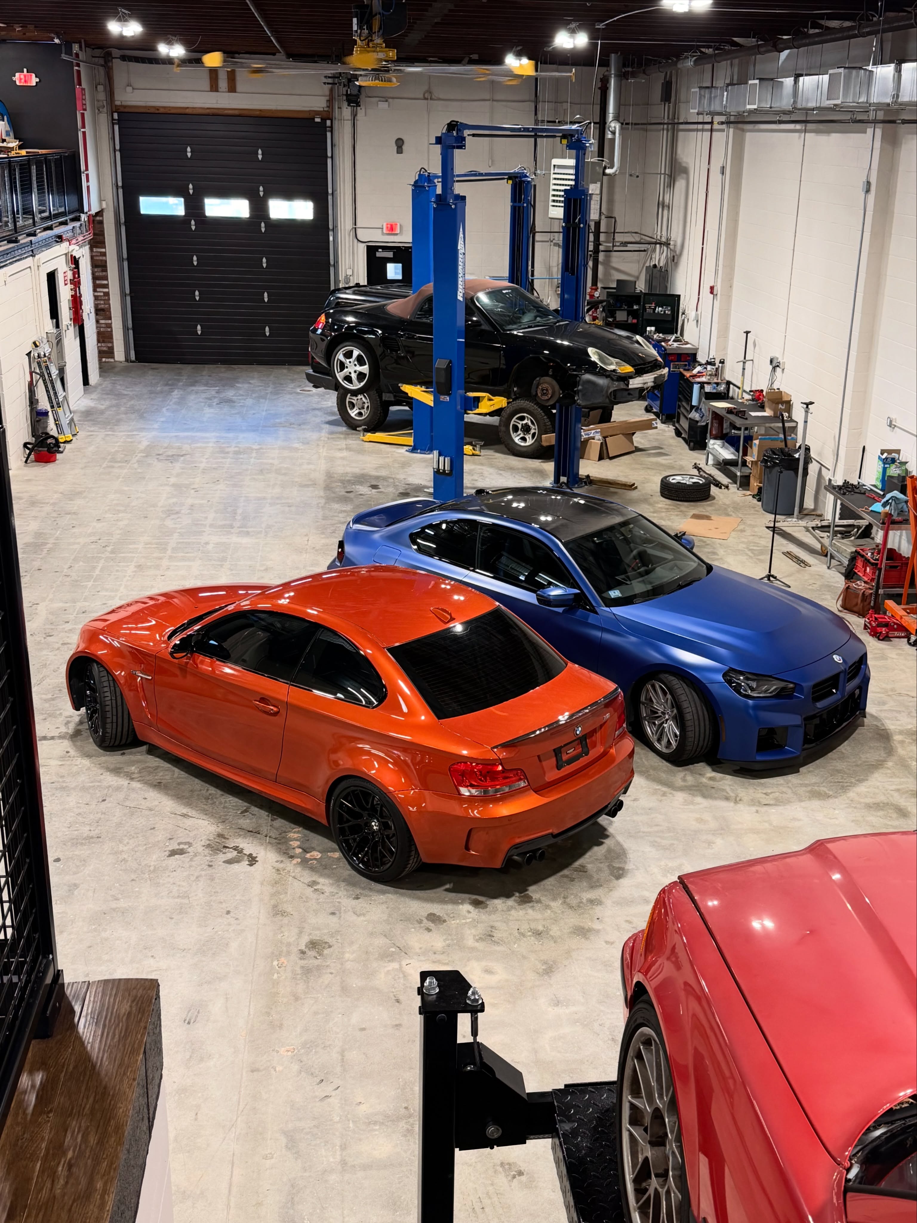 A collection of cars inside the workshop