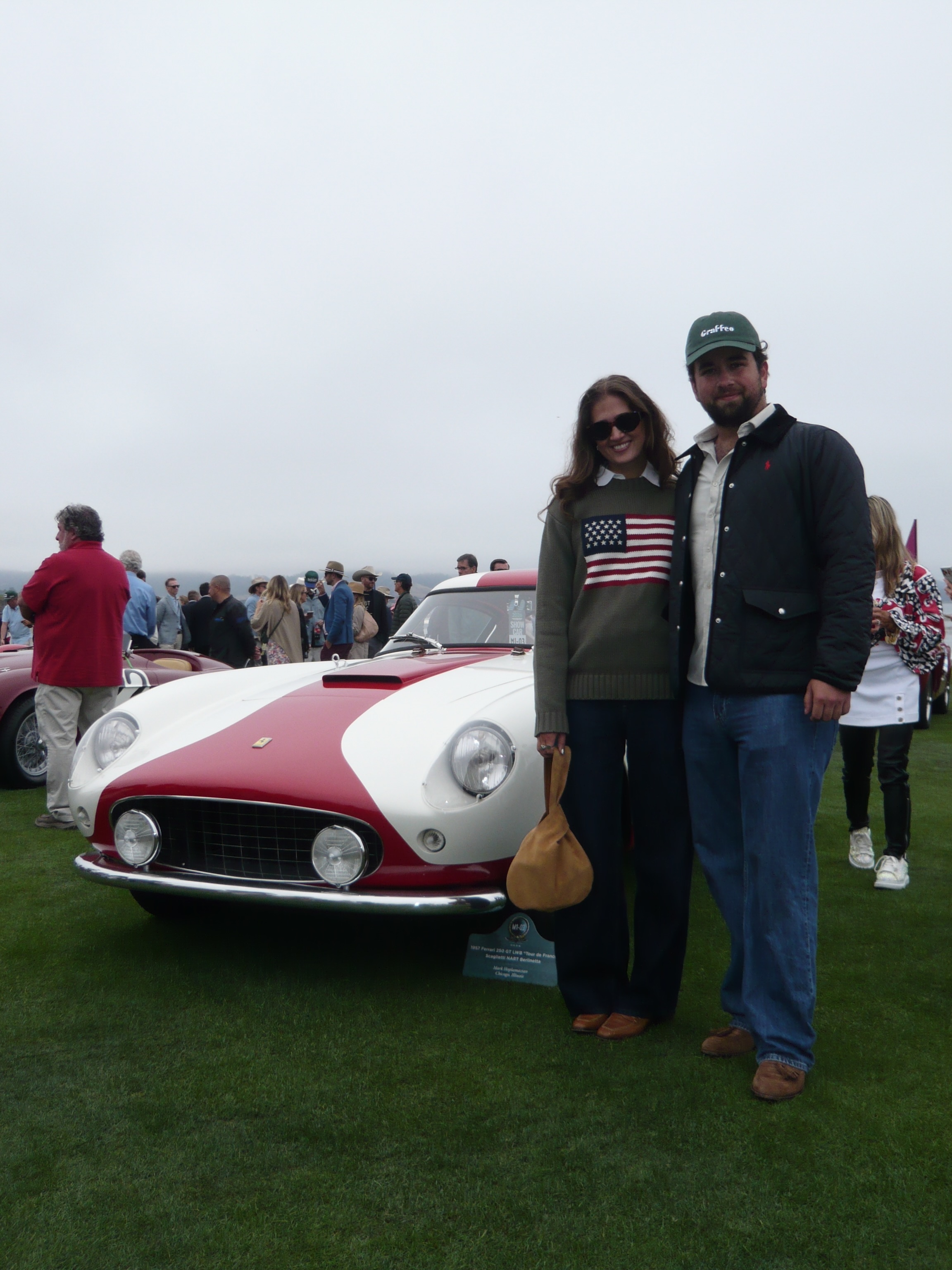 Will at car week beside a vintage Ferrari