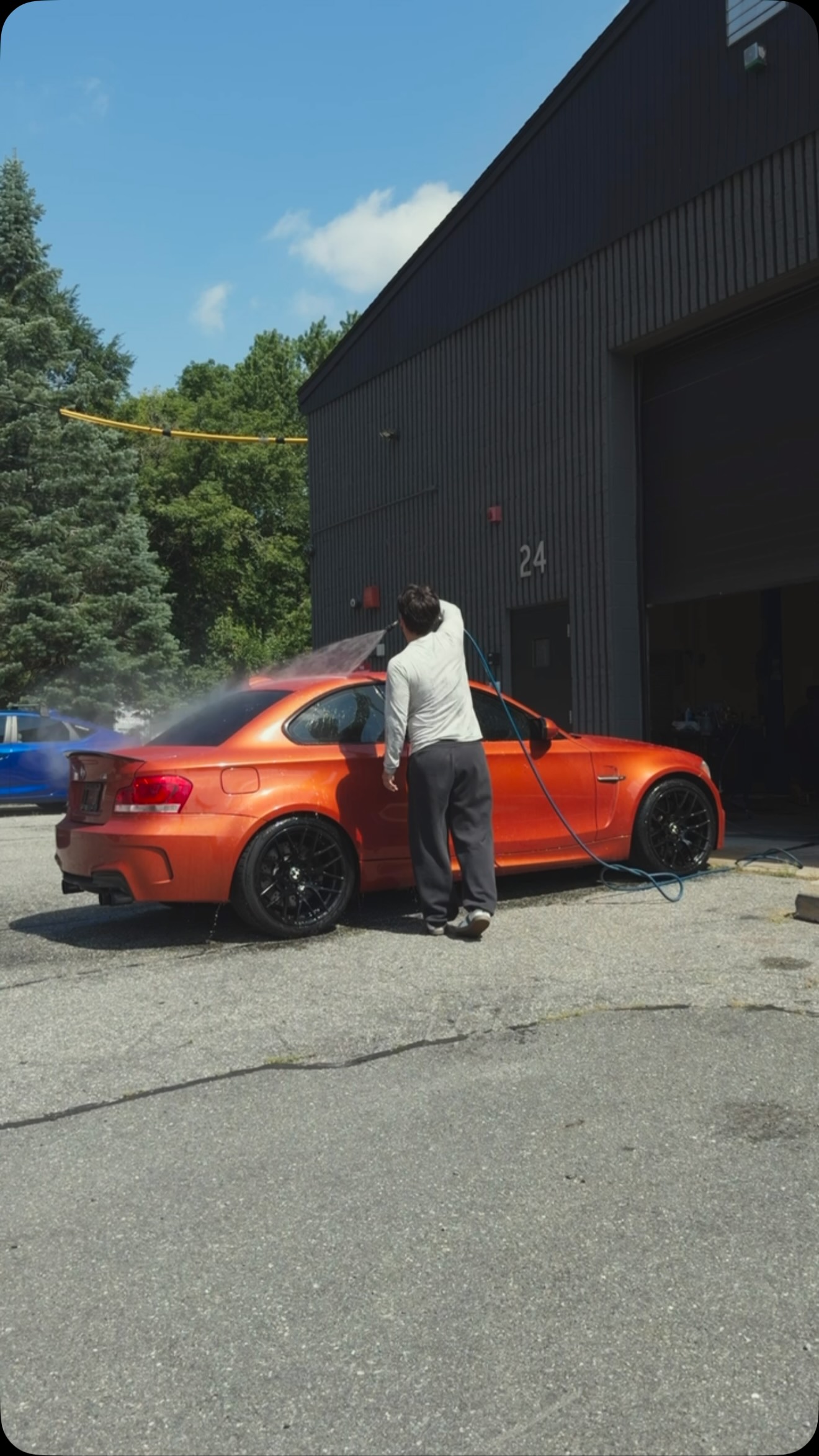 Will washing his orange BMW 1M